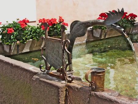 Detail of a copper spout of a fountain in the center of Castelrotto (Kastelruth) - the town is a gateway to the Alpe di Siusi, the largest high Alpine meadow in Europe, and the rugged Dolomites mountainsの写真素材