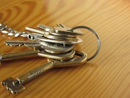 Bunch of worn house keys on wooden table