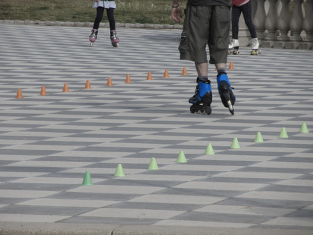 Legs of guy on inline skates . Inline skater and slalom conesの写真素材