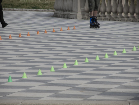 Legs of guy on inline skates . Inline skater and slalom conesの写真素材