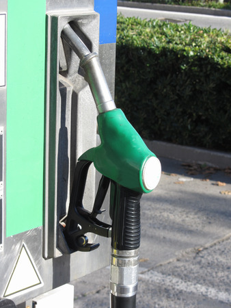 Green fuel pistol on gas station . Unleaded petrol at the pump stationの写真素材