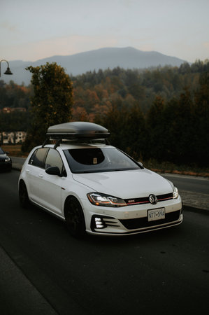 Rear view of a white car on the road in the mountainsのeditorial素材