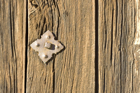 Rusty rivet in wooden door