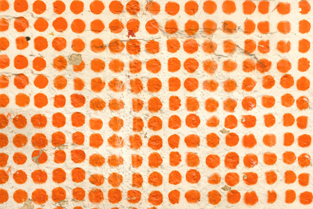 Orange dot pattern in a white wall
