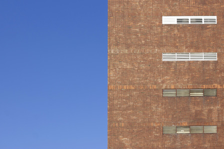 Red brick building with a blue sky.の写真素材