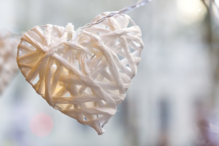 Closeup image of a white paper heart with a small light inside.の写真素材