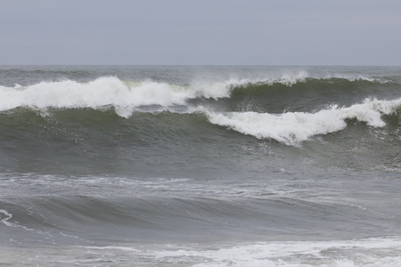 Strong waves crashing before arriving to the shore.の写真素材