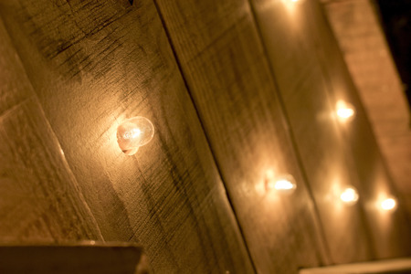 Small lights turned on on a wooden surface.の写真素材