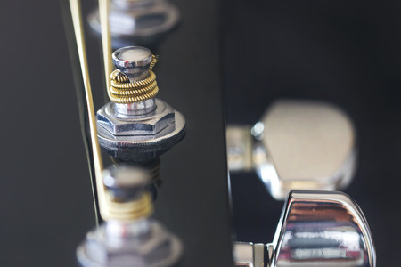 Closeup image of silver tuner post from a guitar.の写真素材