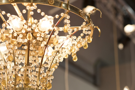 Small details from a chandelier glass lamp turn on.の写真素材