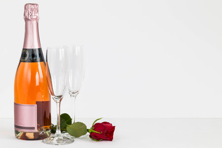 Valentines Day champagne bottle, flutes and roseの写真素材