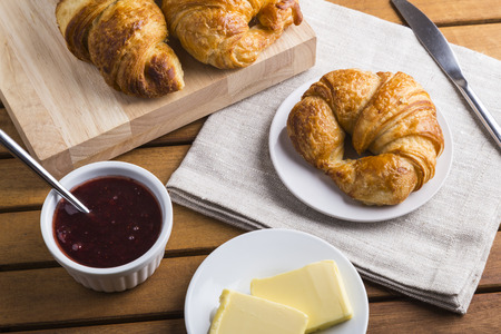 Croissants with jam and butterの写真素材