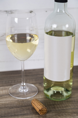 Glass of White Wine with Bottleの写真素材