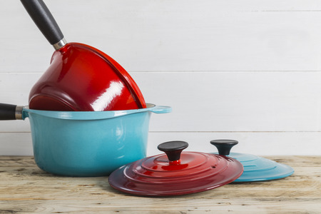 Blue and red saucepans with lidsの写真素材