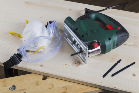Jig saw with goggles and maskの写真素材