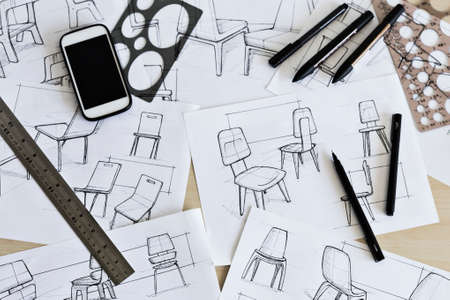 Sketching of ideas for chair designs with drawing implements such as pens, markers, ruler and circle...