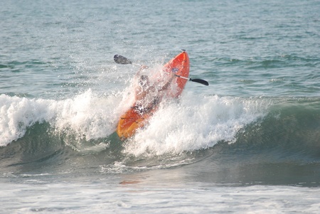 Sayulita Mexico is a surfers paradise known for its long breaks.  This Sit on top kayaker punches a cresting wave on his way past the break.の写真素材