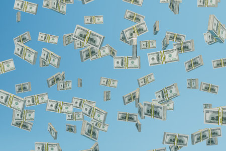 an abstract background consisting of patterns of paper dollars flying across a blue background. 3D rendering.の写真素材