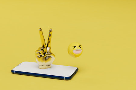 victory hand on a smartphone with smiley emoticon on an yellow background. copy paste, copy space. 3d rendering.の写真素材
