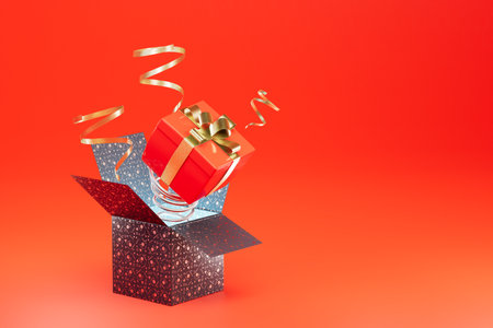 an open box from which a gift box pops out on a spring on a red background. copy paste, copy space....