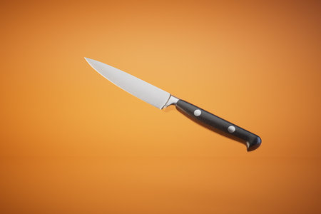 kitchen knife on an orange background. 3D rendering.の写真素材