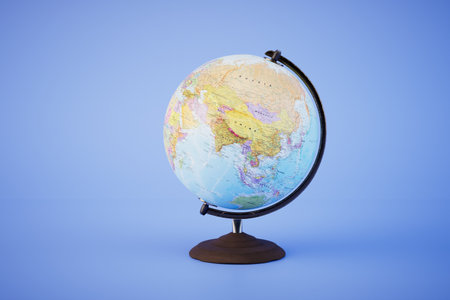 The concept of traveling around the world. Globe on a stand on a blue background. 3D rendering.の写真素材