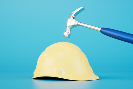 carrying out construction works. hammer and protective helmet on a blue background. 3D rendering.の写真素材
