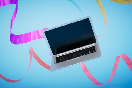 The concept of remote work. An open laptop on a blue background with multi-colored ribbons. 3D...