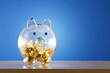 transparent glass piggy bank with gold coins on a blue background. 3d render. illustration.の写真素材