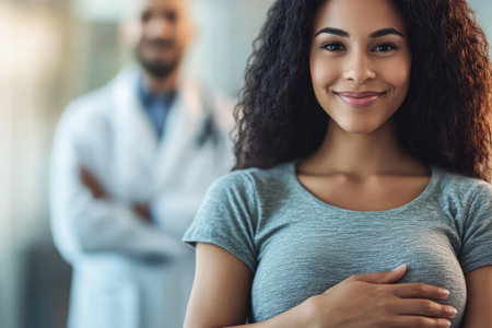 Expecting mother cradling her belly during a medical visit, symbolizing care, maternal health, and emotional connection.の素材