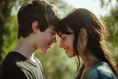 Young teenage couple in love sharing a tender, emotional moment outside, capturing the innocence and warmth of first love.の素材