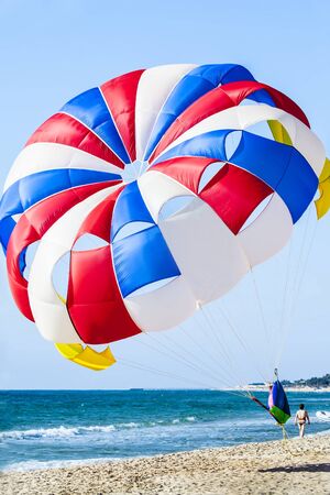 Parachute on the beach. Vacationers are offered to parachute over the sea.の写真素材