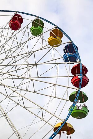 A ferris wheel with panoramic view. A ferris wheel with colorful cabins and the sky on the background.の写真素材