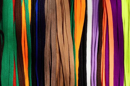 Many multi-colored shoelaces hang on a demo board for sale.                      の写真素材