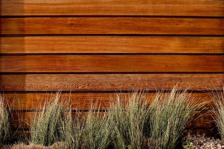 The brown wood texture with natural patterns and grass in a foreground.の写真素材