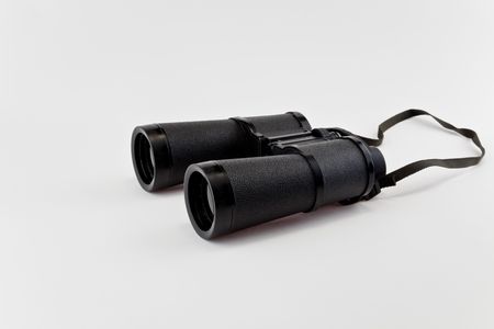 Old binoculars isolated on whiteの写真素材