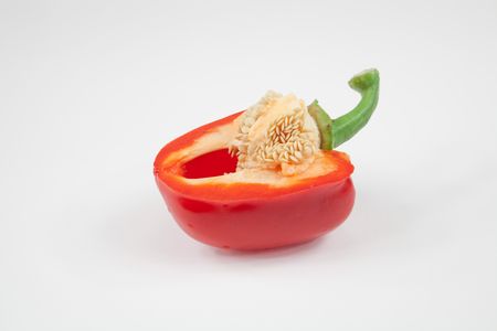 Half cut  red pepper isolated on whiteの写真素材