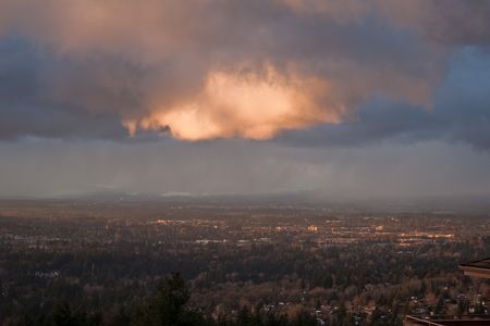 Stormy weather. Photograph depicts a dark cloud highlighted with a ray of sunlight at sunset. の写真素材