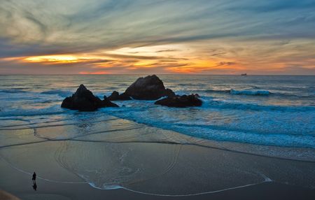 Beach sunset.  Dramatic sunset at the beach on the Pacific Oceanの写真素材