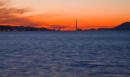 San Francisco Bay at sunset.  Silhouette of Golden Gate Bridge and city skylines at sunset. の写真素材