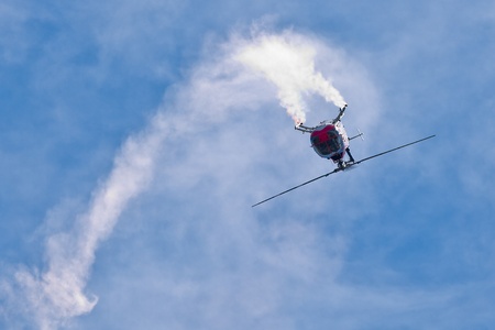 SALINAS, CA - SEPT 25: Pilot Chuck Aaron demonstrates precision of flying and the highest level of pilot skills on Red Bull aerobatic helicopter during the California International Airshow, on September 25, 2011, Salinas, CA.のeditorial素材