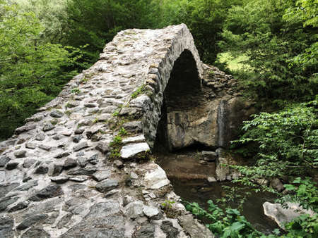 Ancient stone arch bridge in Rkoni across the river Tedzamiの写真素材