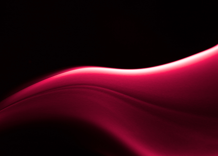 Sharp picture of red curved smoke forms in dark backgroundの写真素材