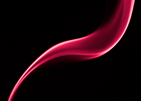 Sharp picture of red curved smoke forms in dark backgroundの写真素材