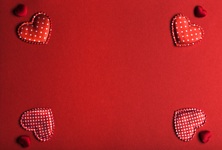 Horizontal red background image with hearts in the cornersの写真素材
