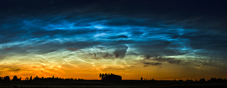 Night landscape with electric line and Noctilucent clouds at Lithuaniaの写真素材