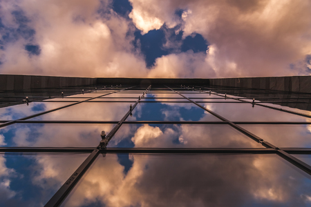 Sky reflection on a shiny glass of a buildingの写真素材