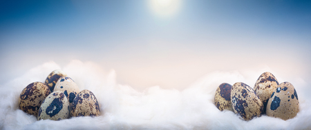 Concept image of small Easter eggs on cloudsの写真素材
