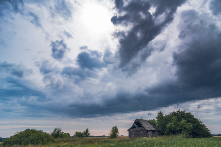 Image of dark Storm clouds above the house in Lithuaniaの写真素材