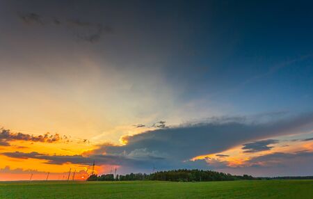 Wind turbines in the beautiful evening light with a storm cloudの写真素材